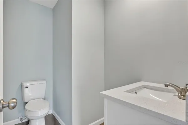 a bathroom with a sink mirror and toilet