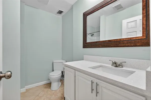 a bathroom with a sink toilet and mirror