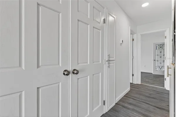 a view of a hallway with wooden floor