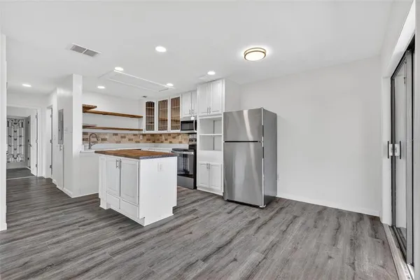 a kitchen with a refrigerator and a sink
