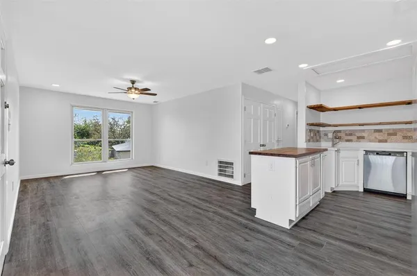 a view of kitchen with wooden floor and electronic appliances