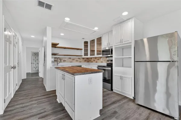 a kitchen with wooden cabinets and white appliances