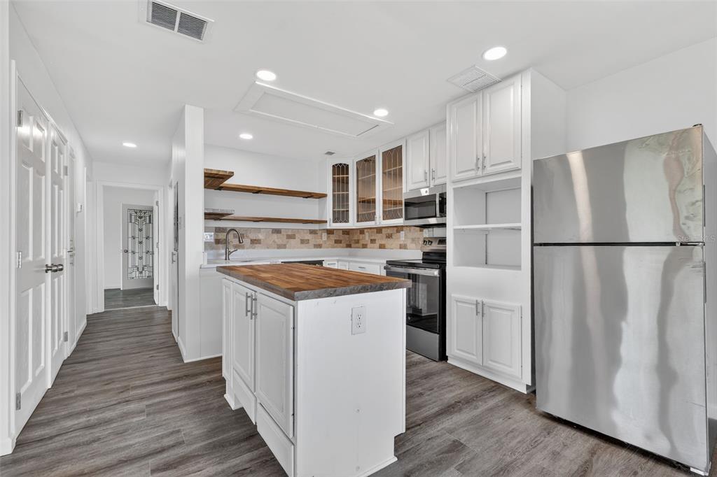 1935 South Conway Road, Unit F6 Orlando, FL 32812 - Photo 10 of 23 a kitchen with wooden cabinets and white appliances