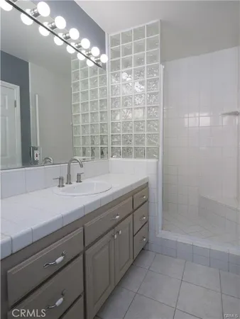 a bathroom with a double vanity sink and a mirror