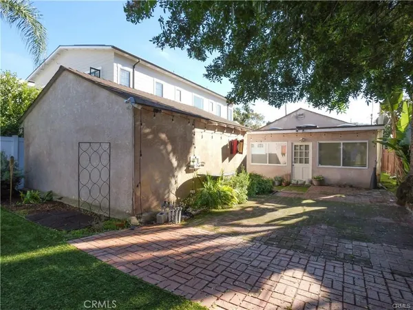 a front view of a house with a yard and outdoor seating