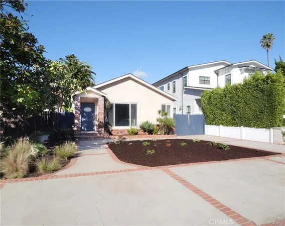 a front view of a house with yard and outdoor seating