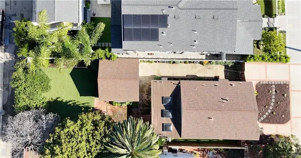 an aerial view of a house with a yard and sitting space