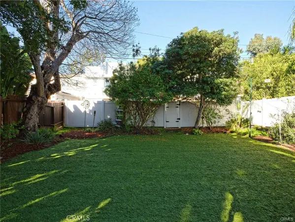a view of a backyard with large trees