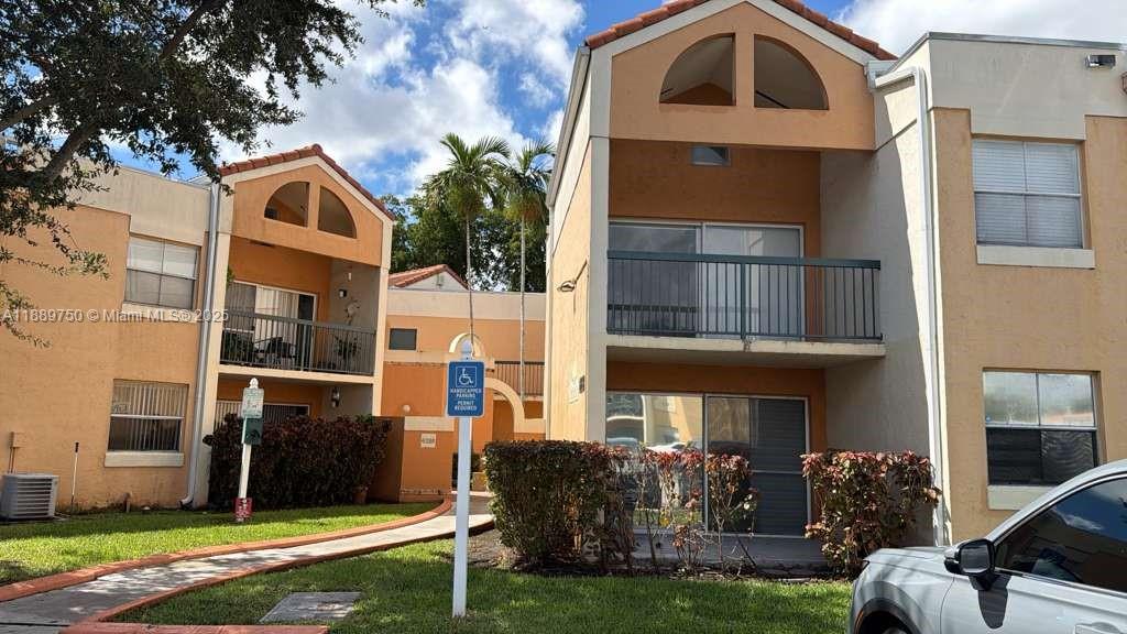 6288 Northwest 186th Street, Unit 201 Hialeah, FL 33015 - Photo 1 of 19 a front view of a house with garden