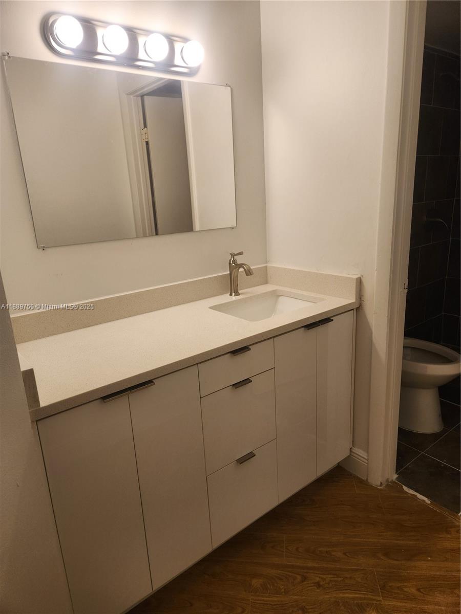 6288 Northwest 186th Street, Unit 201 Hialeah, FL 33015 - Photo 12 of 19 a bathroom with a sink and a mirror