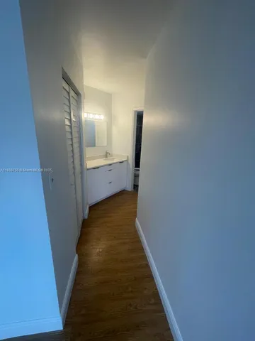 a view of hallway with wooden floor