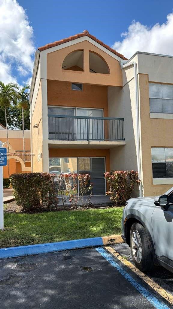 6288 Northwest 186th Street, Unit 201 Hialeah, FL 33015 - Photo 2 of 19 a front view of a house with a yard