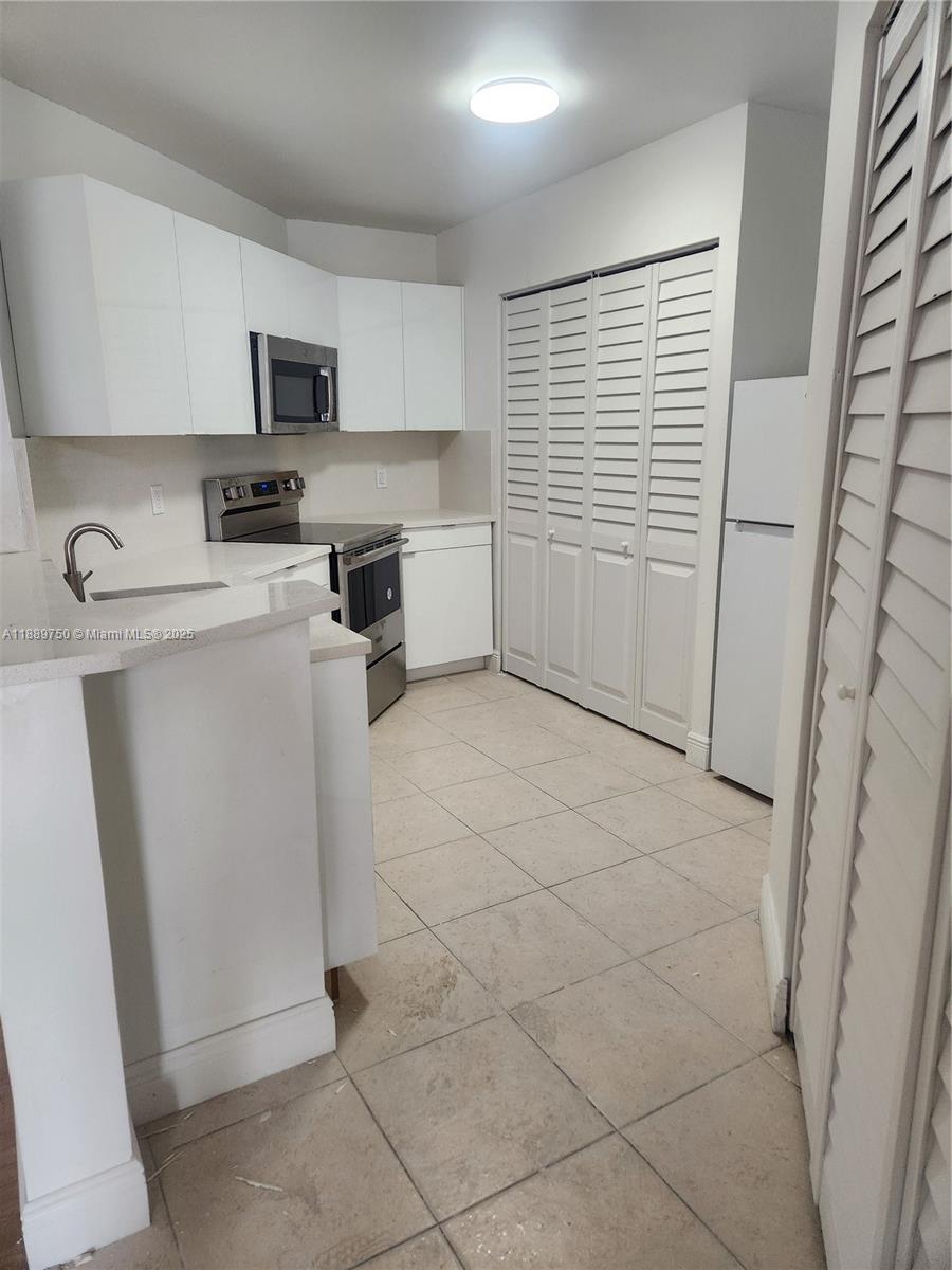 6288 Northwest 186th Street, Unit 201 Hialeah, FL 33015 - Photo 5 of 19 a view of a kitchen with electric appliances