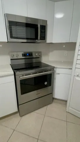 a stove top oven sitting inside of a kitchen