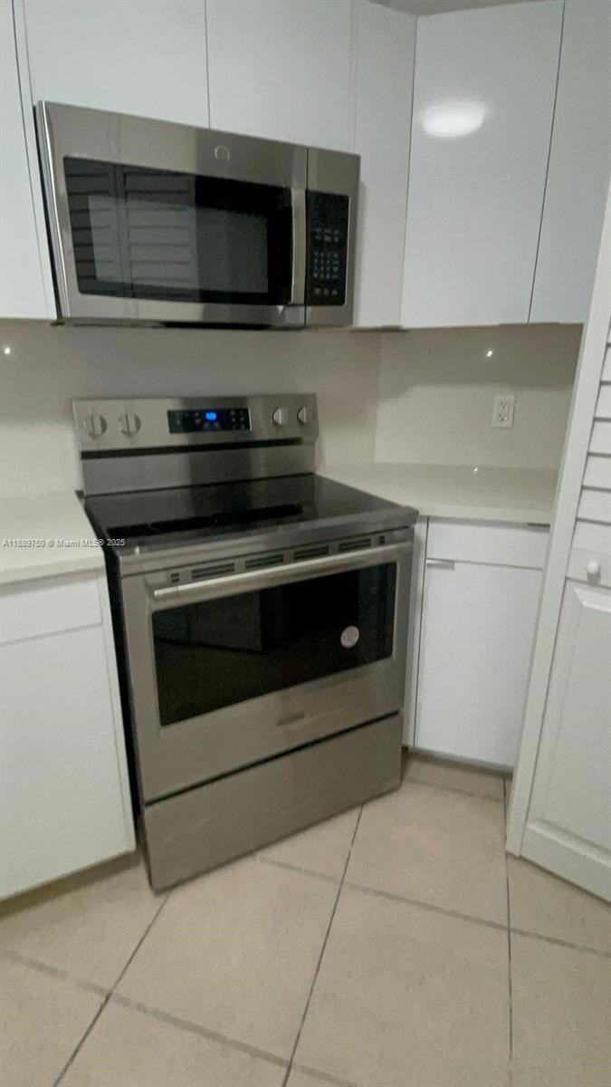 6288 Northwest 186th Street, Unit 201 Hialeah, FL 33015 - Photo 9 of 19 a stove top oven sitting inside of a kitchen
