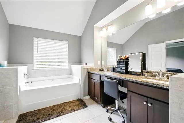 a bathroom with a tub sink and mirror