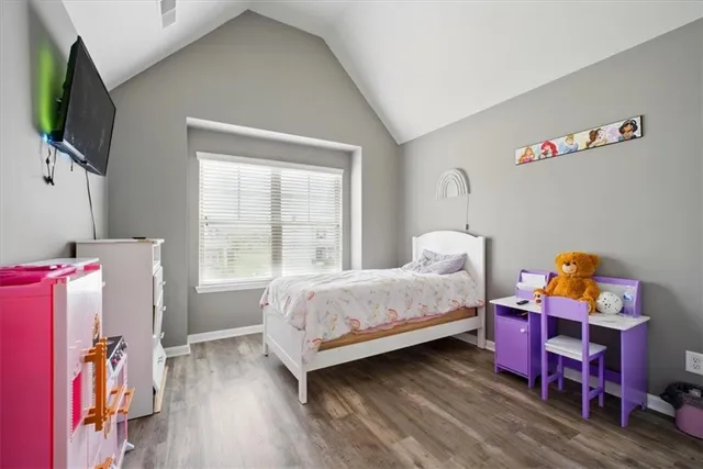 a bedroom with furniture and a flat screen tv