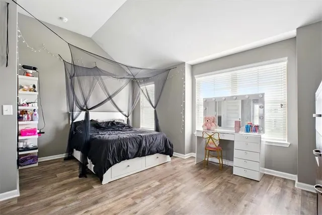 a bedroom with a bed and a desk