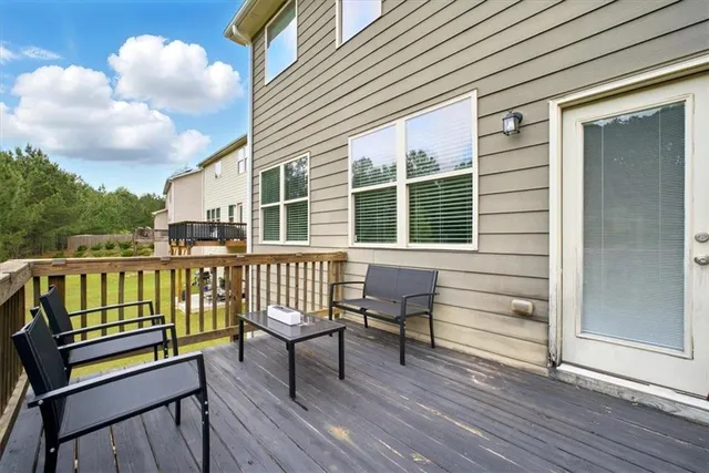 a view of a chair and table on the wooden deck