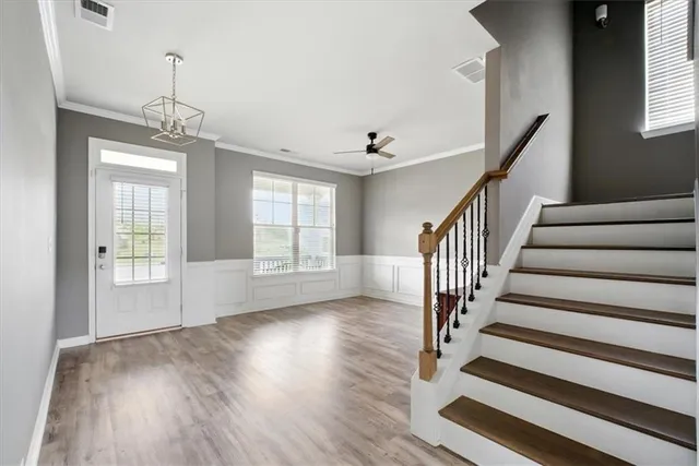 a view of an entryway with wooden floor and stairs