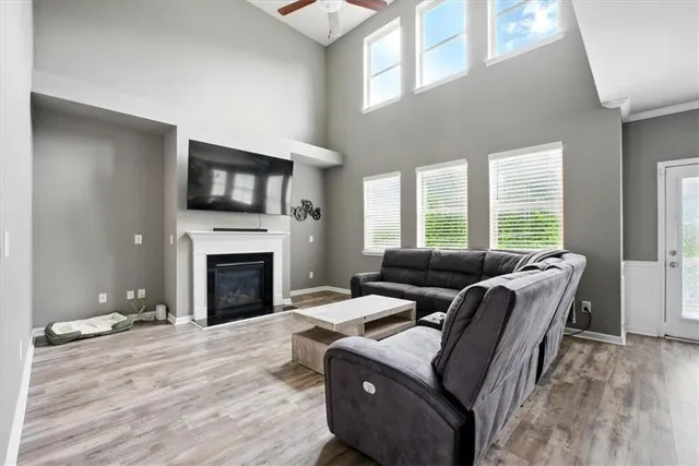 a living room with furniture a flat screen tv and a fireplace