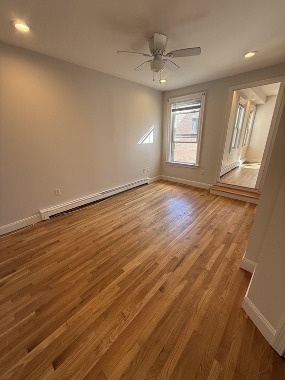 78 Bunker Hill Street, Unit 2 Boston, MA 02129 - Photo 2 of 9 an empty room with wooden floor and windows