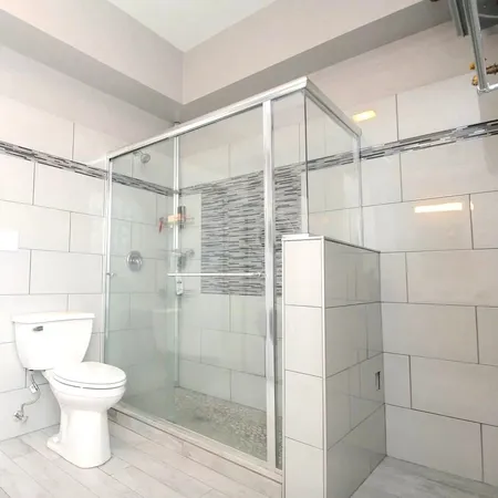 a bathroom with a toilet and a shower