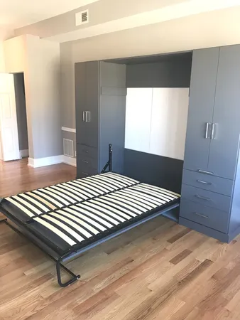 a view of a room with wooden floor and windows