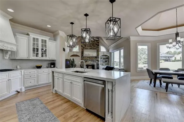 a kitchen with stainless steel appliances granite countertop a refrigerator and cabinets