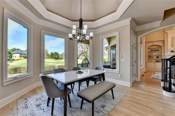 a bedroom with a balcony a bed and a chandelier
