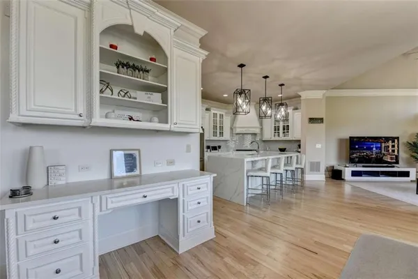 a bathroom with a granite countertop sink a mirror and a bathtub