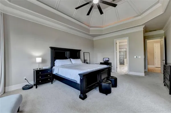 a bedroom with a bed and a large mirror on the dresser