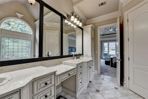 a bathroom with a sink a vanity and a bathtub