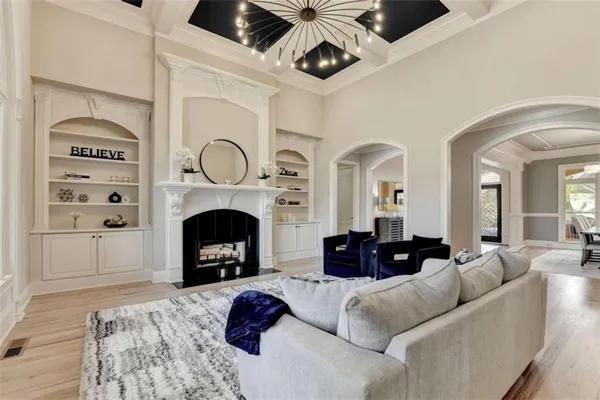 a kitchen with stainless steel appliances granite countertop a stove a microwave and a white cabinets