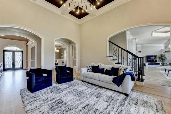 a kitchen with stainless steel appliances kitchen island granite countertop a dining table chairs and white cabinets