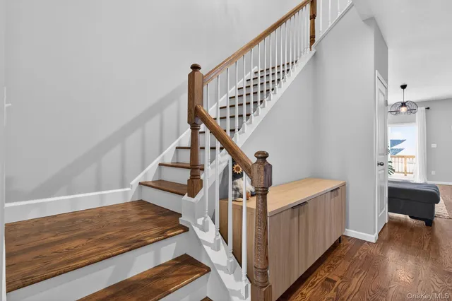 a view of entryway and hall with wooden floor