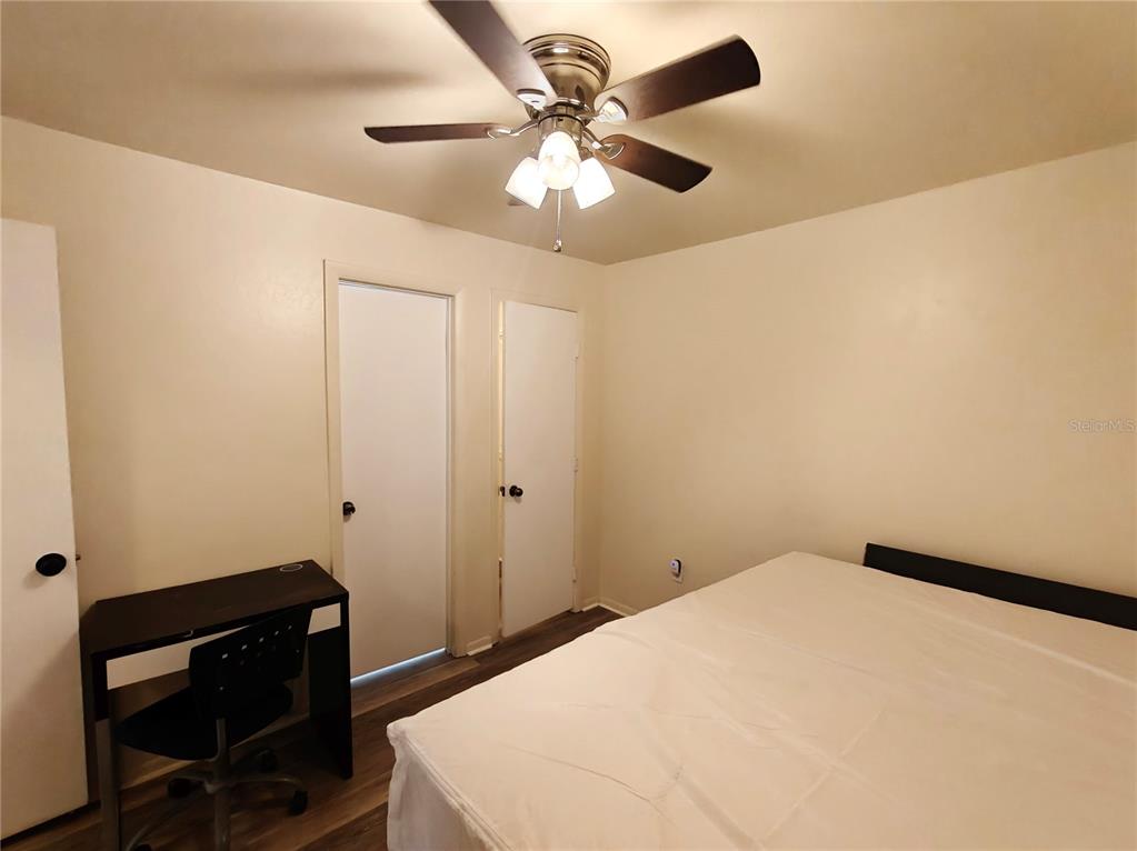 4000 Southwest 23rd Street, Unit 5207 ROOM A Gainesville, FL 32608 - Photo 11 of 17 a bedroom with a bed and a chair