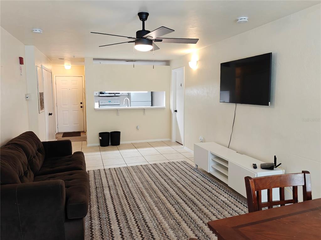 4000 Southwest 23rd Street, Unit 5207 ROOM A Gainesville, FL 32608 - Photo 3 of 17 a living room with furniture and a flat screen tv