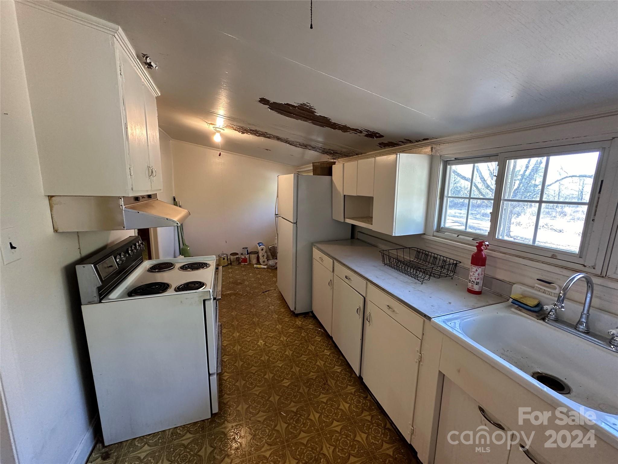 11298 Highway 265 Jefferson, SC 29718 - Photo 13 of 22 a kitchen with stainless steel appliances granite countertop a sink a stove and a refrigerator