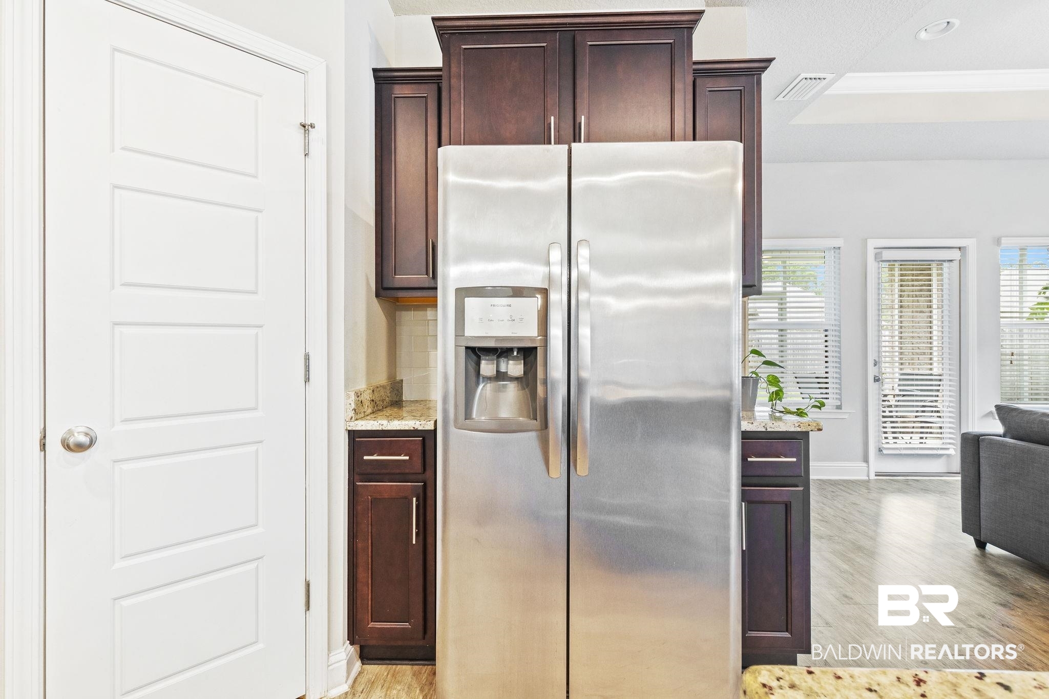31643 Kestrel Loop Daphne, AL 36527 - Photo 14 of 59 Kitchen with stainless steel fridge, light hardwood / wood-style flooring, light stone counters, and backsplash