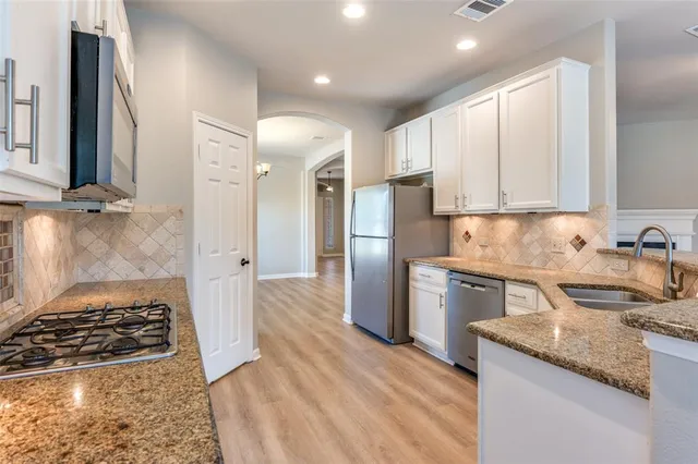 a kitchen with a sink stove and refrigerator