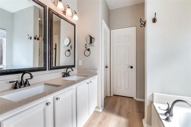 a bathroom with a double vanity sink and mirror