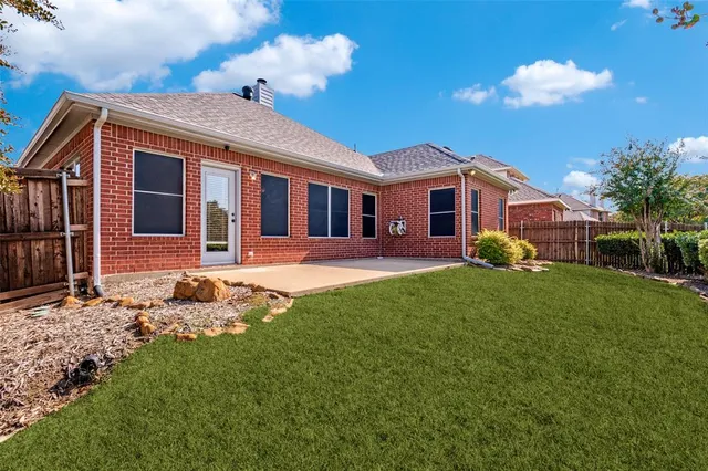 a front view of a house with a yard porch and tree