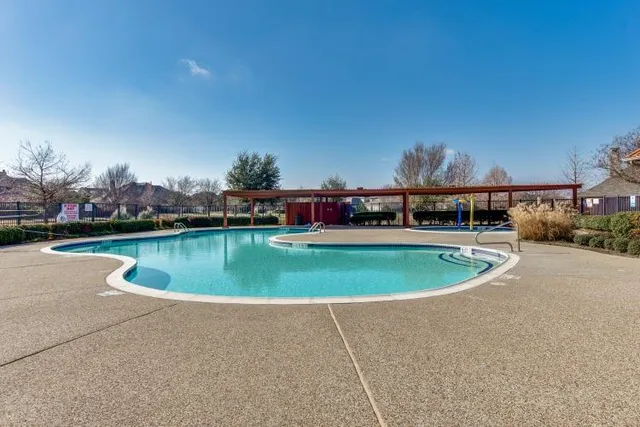 a view of a swimming pool and a yard