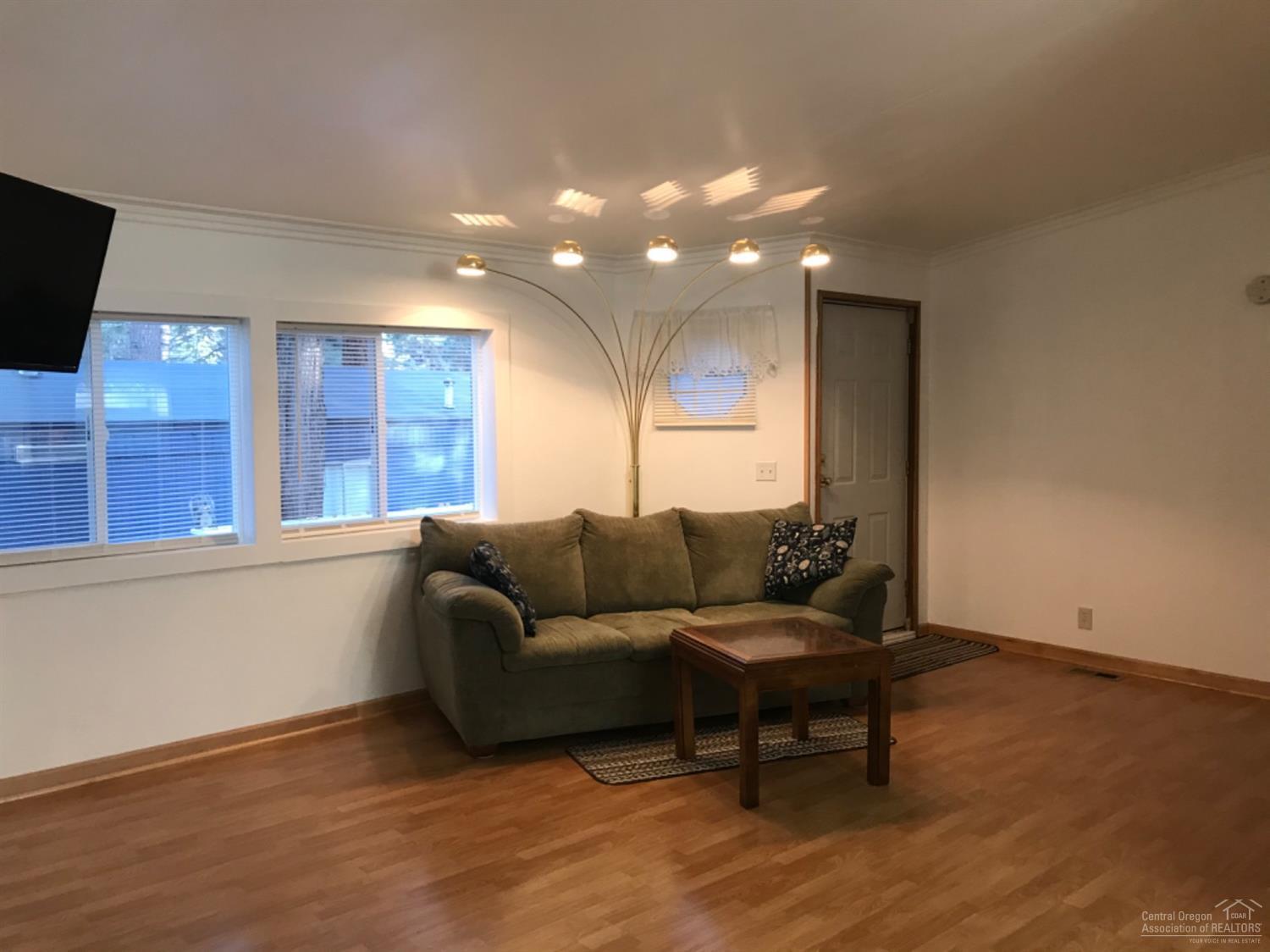 60901 Brosterhous Road, Unit 755 Bend, OR 97702 - Photo 7 of 23 a living room with furniture and a flat screen tv