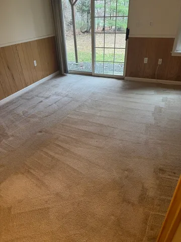 a view of a closet with wooden floor and a table