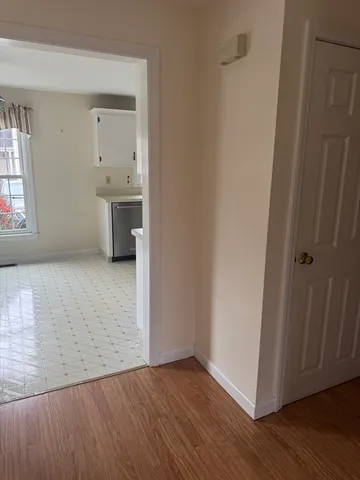 a view of a room with wooden floor and sink