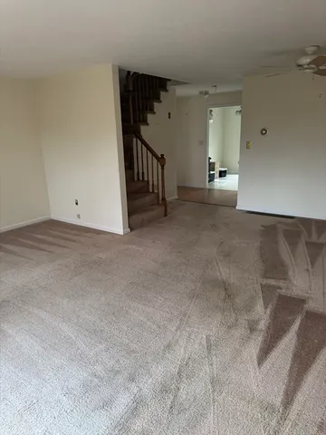 a view of a big room with closet and windows