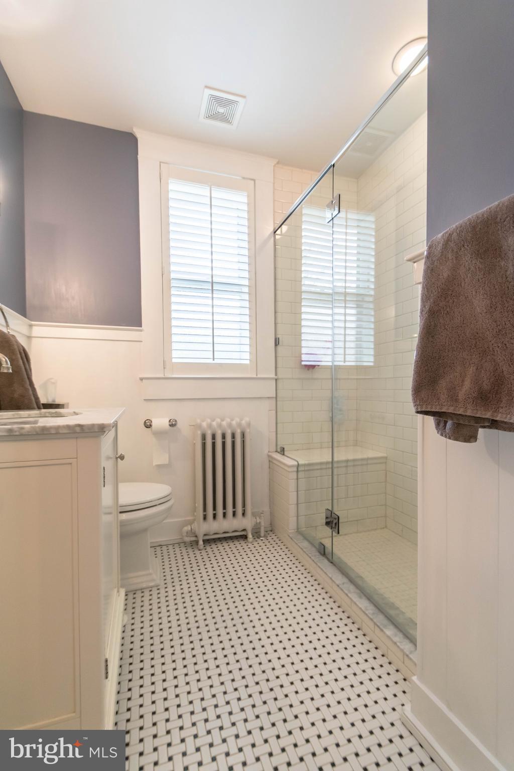 4105 Roland Avenue Baltimore, MD 21211 - Photo 14 of 28 a bathroom with a sink a toilet a window and shower