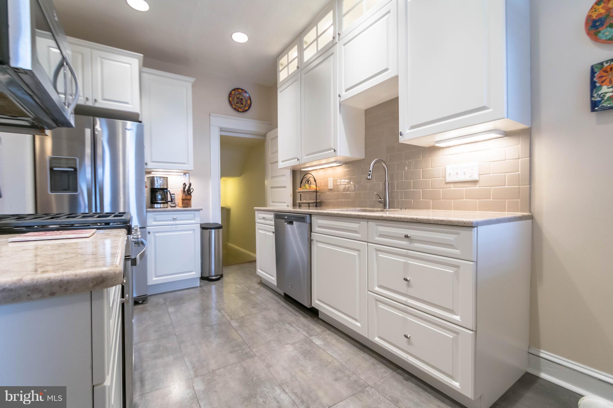 4105 Roland Avenue Baltimore, MD 21211 - Photo 8 of 28 a kitchen with cabinets and window